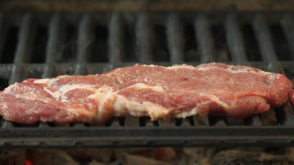 Cooking rib-eye steaks on grill panorama