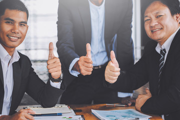 business team join hands after working on Discussing plan and idea to improvement strategy at meeting room,