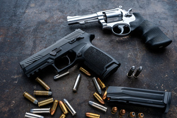 Hand guns , ammo ,Guns with ammunition on Dark background. 
