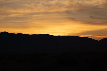 Orange sunrise with mountain silhouette
