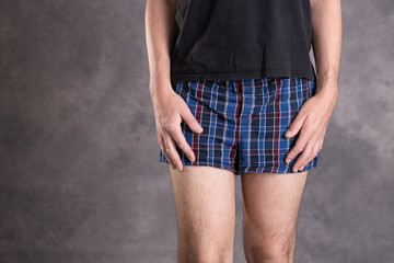 man in blue plaid boxer shorts