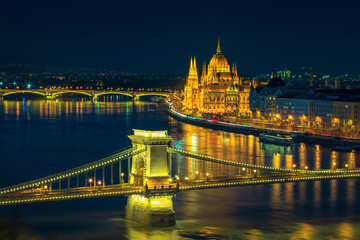Fototapeta na wymiar Iluminated Chain bridge and Parliament building at night, Budapest, Hungary