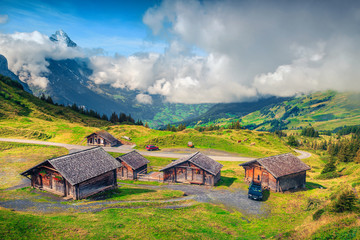 Fototapeta na wymiar Alpine wooden farmhouses and mountain farmland, Grindelwald, Bernese Oberland, Switzerland