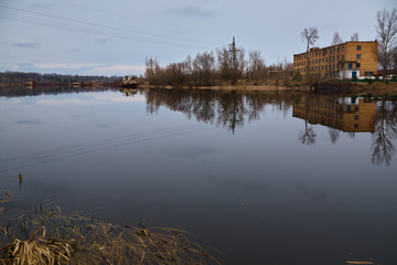 The abandoned river port in Pripyat. Abandoned ships in the river near of Chernobyl. Modern ruins....