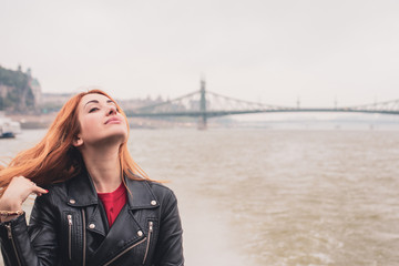 Obraz premium Tourism concept. Beautiful woman look at view of city streets, centre of city . Vacation in Budapest