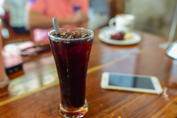 Black coffee, reception table, relaxation with food and drinks, focus on the glass and blur the background