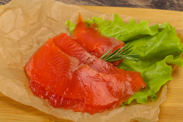 Sliced salmon fillet served rosemary