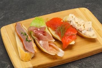 Tapas - bruschetta with prosciutto, salmon, duck and gorgonzola
