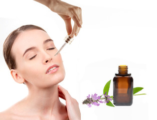Obraz na płótnie Canvas Girl dripping on the skin serum for the face of natural herbs