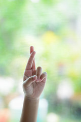 The girl is making a sign showing that she is lying.