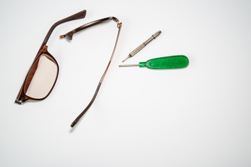 Broken glasses and repair tools