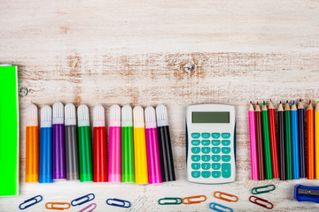 Items for the school on a wooden table.
