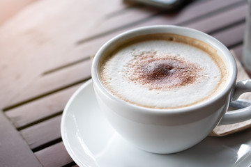 Hot coffee and hot tea place on the wooden table in early morning with copyspace, white cup and silver spoon.