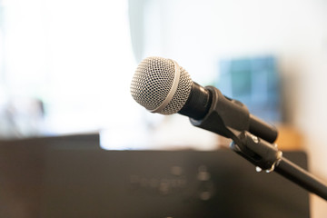Microphone on abstract blurred of speech in  room or speaking conference Event Background