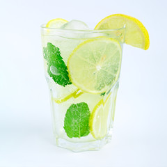 Mojito cocktail with lemon and mint in highball glass, isolated on a white background.