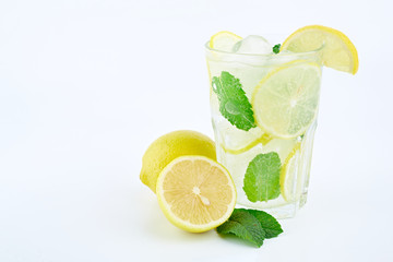 Mojito cocktail with lemon and mint in highball glass, isolated on a white background.