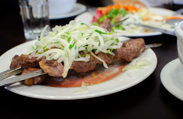 Beautiful shish kebab or shashlik on skewers served at small asian cafe