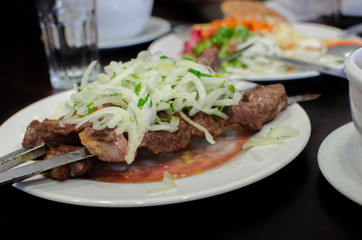 Beautiful shish kebab or shashlik on skewers served at small asian cafe