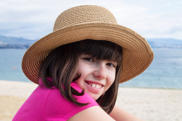 portrait of girl with hat on the beach