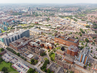 Obraz premium Aerial photo of the St. James's University Hospital in Leeds, West Yorkshire, England, showing the Hospital, A&E entrance and grounds and also the Leeds City Centre in the background on a sunny day.