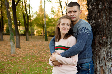 Fototapeta premium Happy Couple in Autumn Park. Fall. Young Family Having Fun