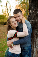 Happy Couple in Autumn Park. Fall. Young Family Having Fun