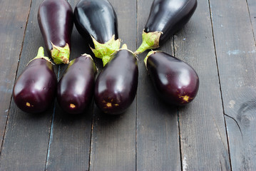 eggplants on black wood table background