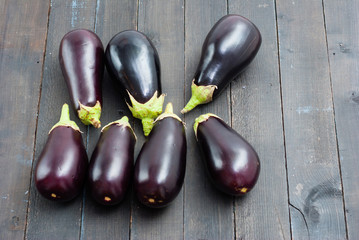 eggplants on black wood table background