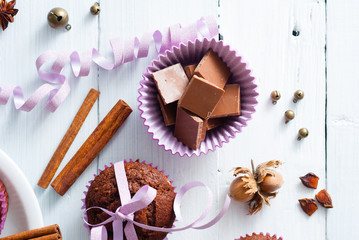 chocolate muffins with hazelnuts on white wooden