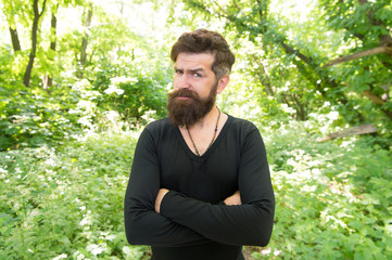 Naklejka na ściany i meble His beard style looks great. Brutal hipster wearing fashionable mustache and beard hair style. Bearded man keeping arms crossed in casual style on summer day. There is style for every man