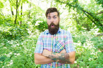 Naklejka na ściany i meble Emotional nature lover. Guy relax in summer nature. Man handsome beard and mustache in summer forest. Summer vacation concept. United with environment. Man bearded hipster green trees background