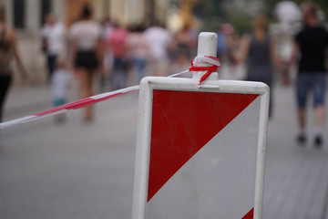 orange white cones and red white stretched tape for traffic and Parking restrictions. prohibited Parking spaces.