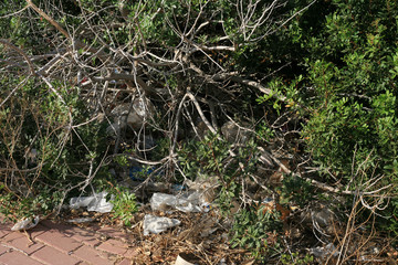 Naklejka na ściany i meble Litter and discarded plastic in a tourist town. Mazarron in Murcia, Spain.