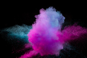 Colored powder explosion on black background.