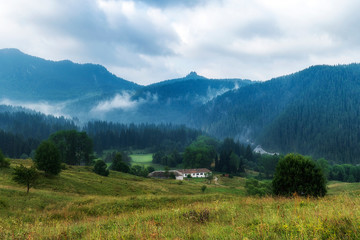 Fototapeta na wymiar Foggy morning over Chairski lakes chalet in Rhodope mountain, Bulgaria