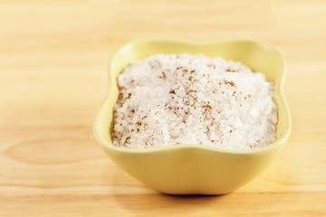 crystals white salt in a green light ceramic bowl on a wooden table base design culinary