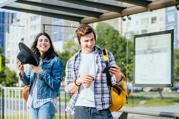 Students while break sitting on stairs of the university using mobile phones and paying no...