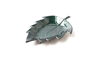 Empty green ceramic leaf dish on white