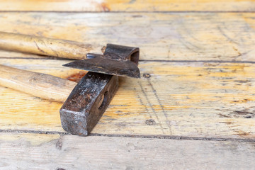 ax and hammer for construction of houses on a light wooden background base copy space background