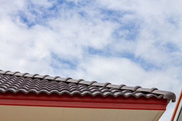 The gable roof with the sky with clouds background.