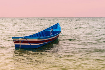 Naklejka na ściany i meble blue boat open ocean sea sunset night fishing recreation background base traditional prey fish