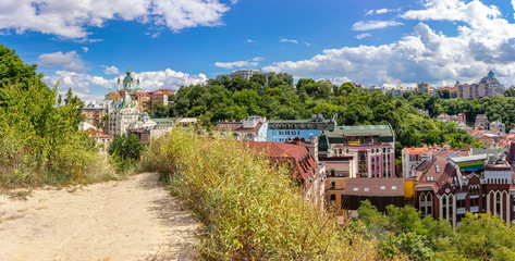 Panorama of historical part of Kyiv city with Andriivska church on Andriyivskyy descent, Vozdvyzhenka with ancient colorful buildings, Ukraine