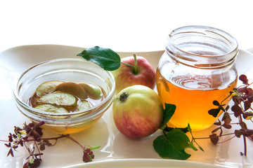 Honey and apples isolated on a wooden board. These sweet food attributes are symbols of Jewish New Year - Rosh ha - Shanah