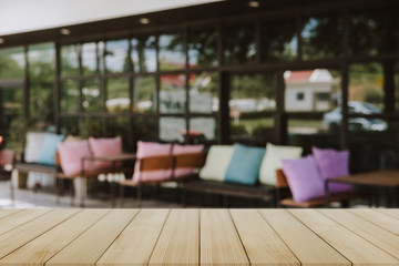 Empty wooden table blurred of restaurant cafe background and reception room, can be used for display or montage your products