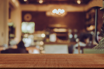 Empty wooden table blurred of restaurant cafe background and reception room, can be used for display or montage your products