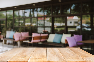 Empty wooden table blurred of restaurant cafe background and reception room, can be used for display or montage your products