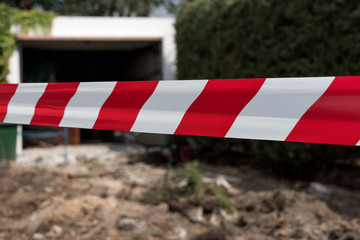 Barrier red and white tape. Construction site shutdown due to risk of injury