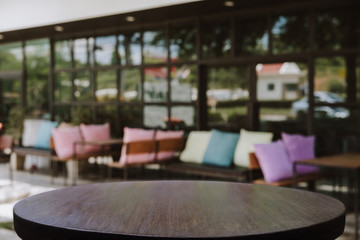 Empty wooden table blurred of restaurant cafe background and reception room, can be used for display or montage your products