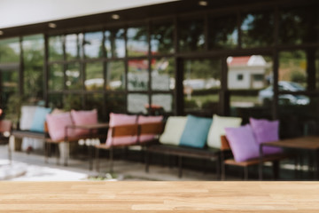 Empty wooden table blurred of restaurant cafe background and reception room, can be used for display or montage your products