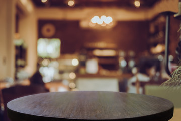 Empty wooden table blurred of restaurant cafe background and reception room, can be used for display or montage your products